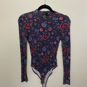 Flowered body suit, long sleeve.